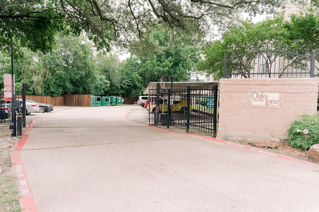 6646 E Lovers Ln Unit 301, Dallas, TX 75214 - view of concrete road featuring view of wooded area