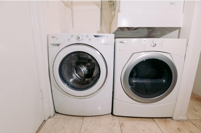 6646 E Lovers Ln Unit 301, Dallas, TX 75214 - washroom with separate washer and dryer and light tile patterned floors