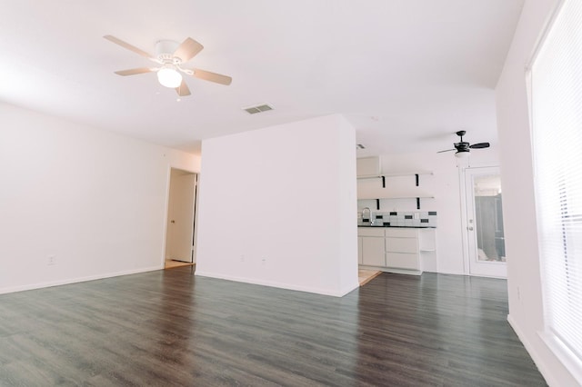 6646 E Lovers Ln Unit 301, Dallas, TX 75214 - unfurnished living room featuring a ceiling fan and dark wood-type flooring