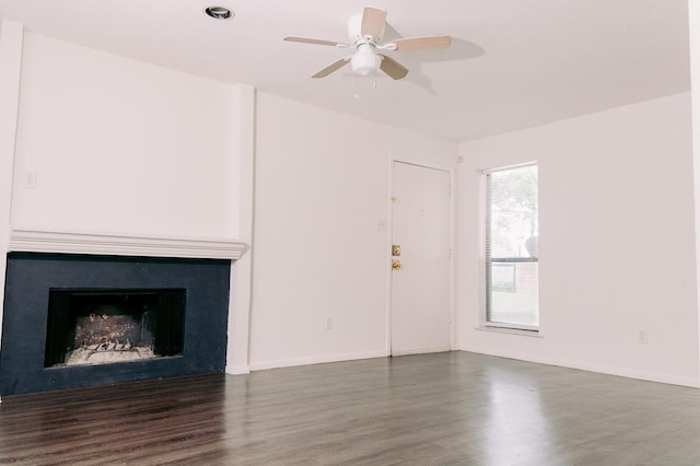 6646 E Lovers Ln Unit 301, Dallas, TX 75214 - unfurnished living room with wood finished floors, a ceiling fan, a fireplace, and baseboards
