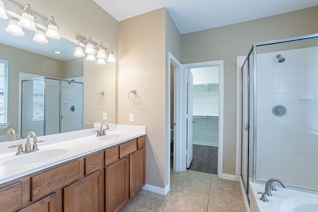 7001 Bickers Dr, Rowlett, TX 75089 - full bathroom with a stall shower, double vanity, tile patterned flooring, a walk in closet, and a bathtub