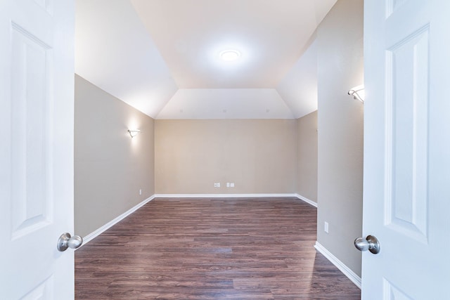 7001 Bickers Dr, Rowlett, TX 75089 - bonus room featuring dark wood finished floors, vaulted ceiling, and baseboards