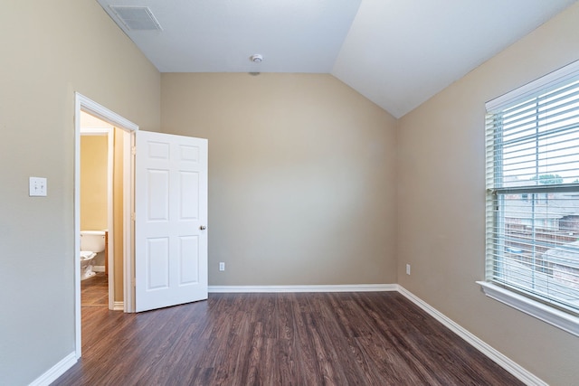 7001 Bickers Dr, Rowlett, TX 75089 - unfurnished room with dark wood-style flooring, baseboards, and lofted ceiling