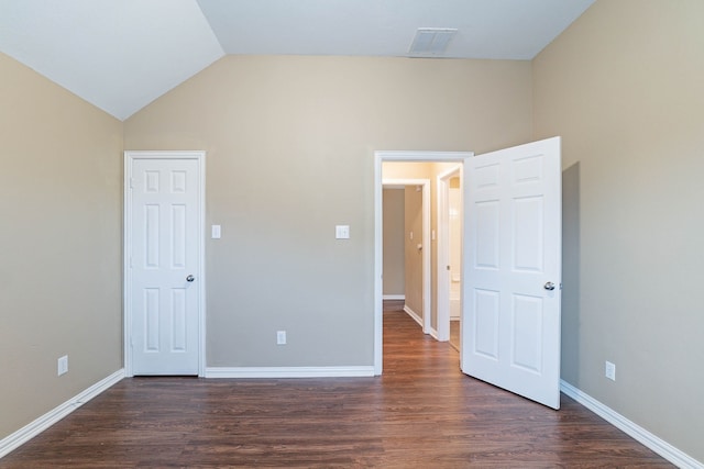 7001 Bickers Dr, Rowlett, TX 75089 - unfurnished bedroom with dark wood-style floors, lofted ceiling, and baseboards