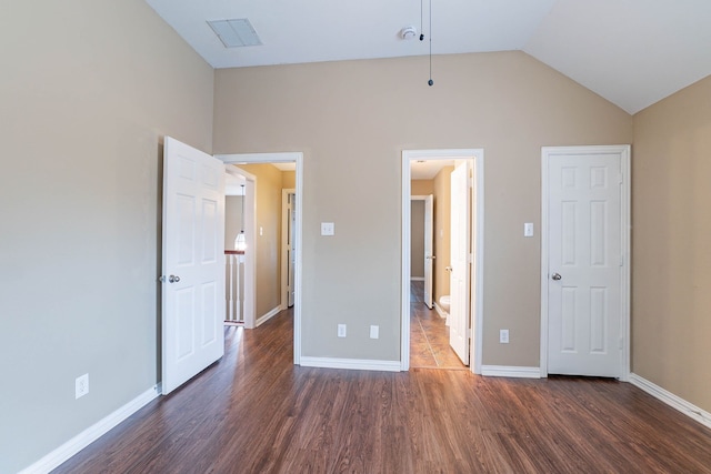 7001 Bickers Dr, Rowlett, TX 75089 - unfurnished bedroom featuring dark wood finished floors, lofted ceiling, and baseboards