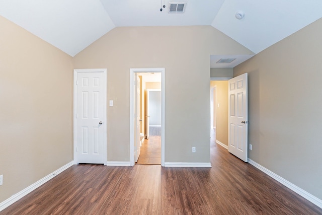 7001 Bickers Dr, Rowlett, TX 75089 - unfurnished bedroom with wood finished floors, lofted ceiling, and baseboards