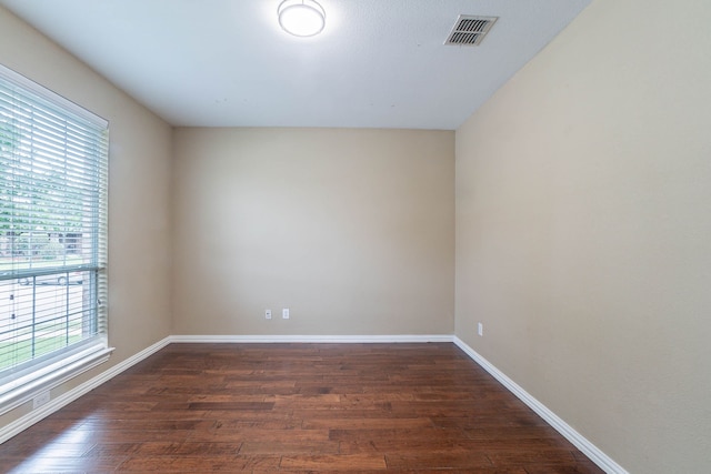 7001 Bickers Dr, Rowlett, TX 75089 - unfurnished room with dark wood-style floors and baseboards