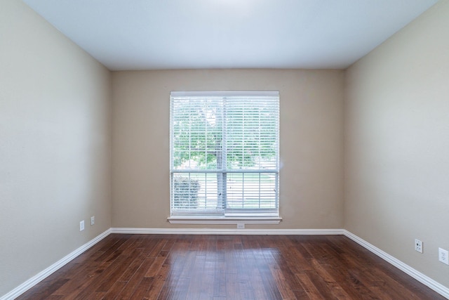 7001 Bickers Dr, Rowlett, TX 75089 - empty room with dark wood-type flooring and baseboards