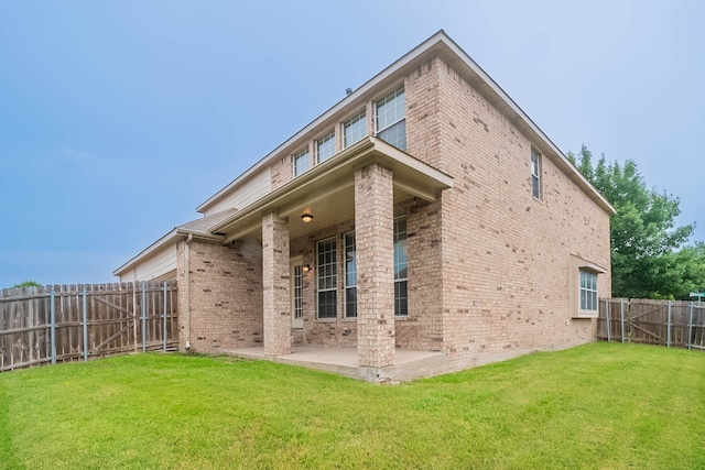 7001 Bickers Dr, Rowlett, TX 75089 - back of house with brick siding and a patio