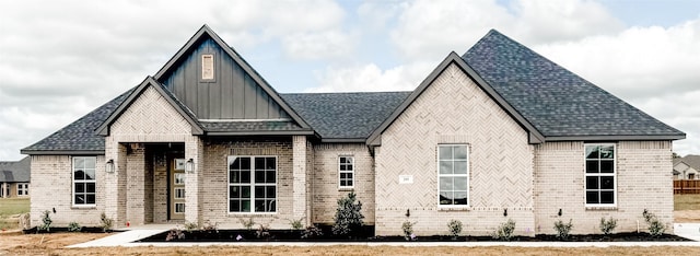 205 Stuart, Paradise, TX 76073 - view of front of home featuring brick siding, board and batten siding, and a shingled roof
