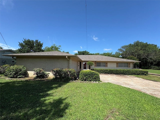 1605 NE 17th, Paris, TX 75460 - ranch-style house with a garage, brick siding, a front yard, and driveway