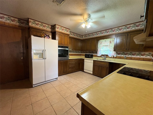 1605 NE 17th, Paris, TX 75460 - kitchen featuring white appliances, ceiling fan, light tile patterned floors, a textured ceiling, and a sink