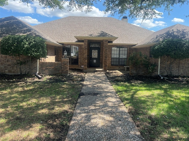 4158 Briargrove Ln, Dallas, TX 75287 - view of front of house featuring brick siding, a front lawn, a chimney, and roof with shingles