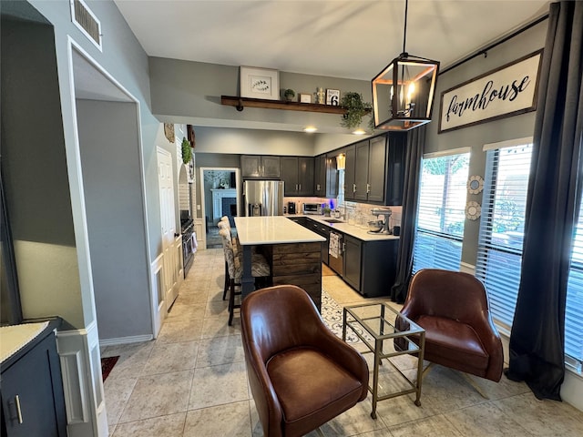 3904 Davis Cir, Plano, TX 75023 - kitchen featuring stainless steel fridge, light countertops, oven, a kitchen island, and a breakfast bar