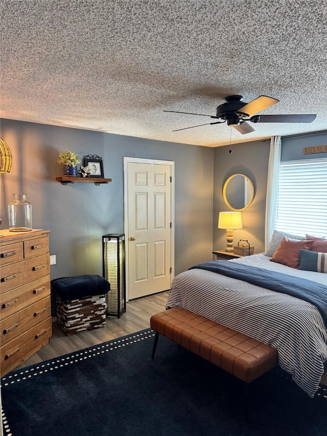 3904 Davis Cir, Plano, TX 75023 - bedroom featuring wood finished floors, ceiling fan, and a textured ceiling