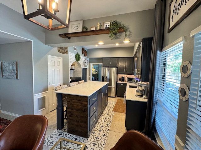 3904 Davis Cir, Plano, TX 75023 - kitchen with stainless steel fridge, light countertops, a center island, and light tile patterned flooring
