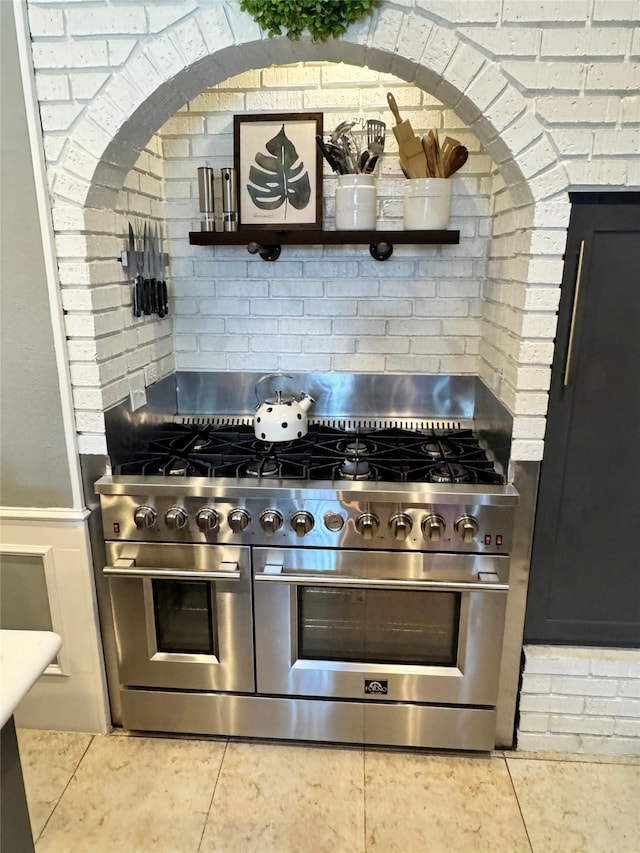 3904 Davis Cir, Plano, TX 75023 - kitchen featuring stainless steel stove, tile patterned flooring, and backsplash