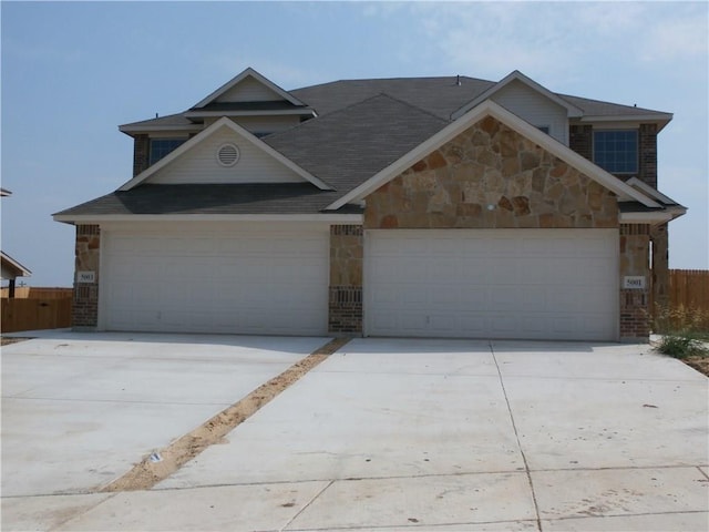 5001-5003 Sanger Circle Dr, Sanger, TX 76266 - view of front of house featuring stone siding, concrete driveway, and a garage