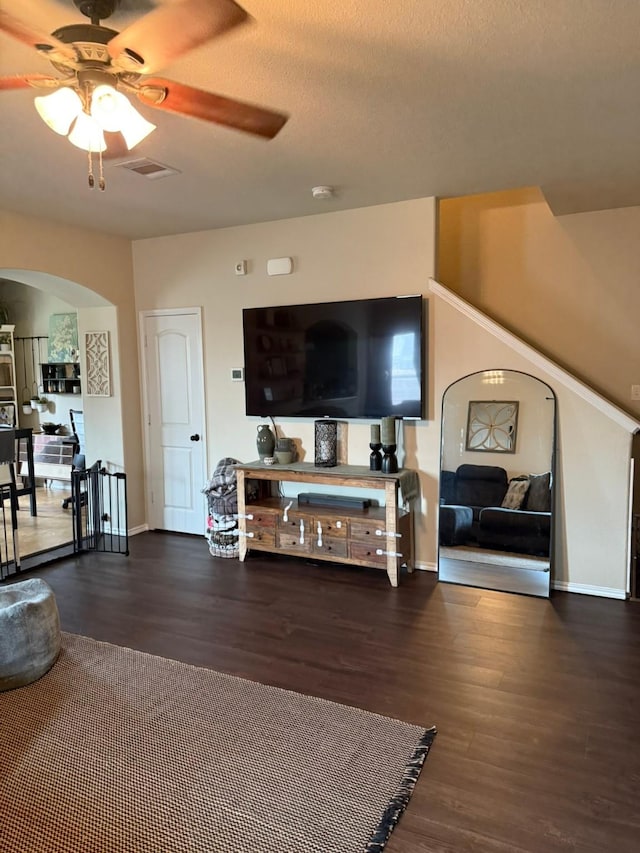 5001-5003 Sanger Circle Dr, Sanger, TX 76266 - living area with arched walkways, wood finished floors, a ceiling fan, and baseboards
