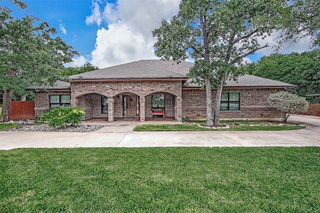 3307 Shawnee Trl, Lake Worth, TX 76135 - french country home with brick siding, a front yard, covered porch, and a shingled roof