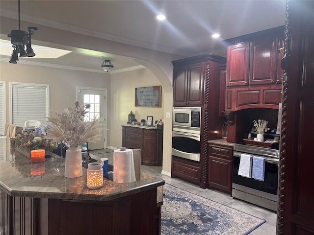 3307 Shawnee Trl, Lake Worth, TX 76135 - kitchen featuring appliances with stainless steel finishes, dark brown cabinets, crown molding, arched walkways, and recessed lighting