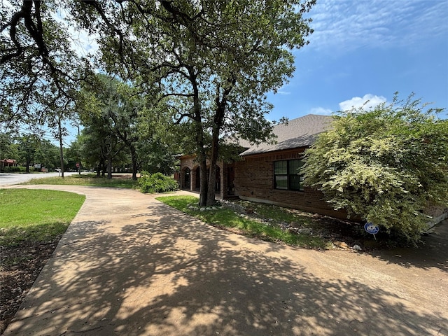3307 Shawnee Trl, Lake Worth, TX 76135 - view of property exterior with brick siding and concrete driveway
