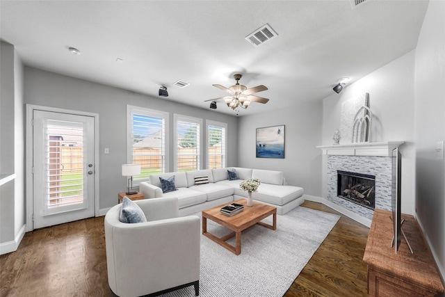 1557 Crystal Pass, Allen, TX 75002 - living room with a fireplace, dark wood-type flooring, and a ceiling fan