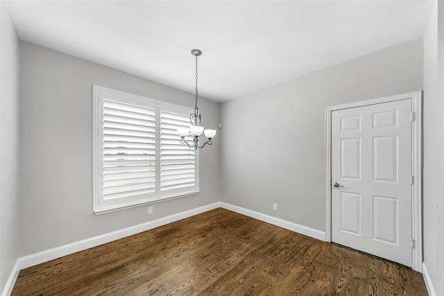 1557 Crystal Pass, Allen, TX 75002 - spare room featuring a chandelier and dark wood-style floors