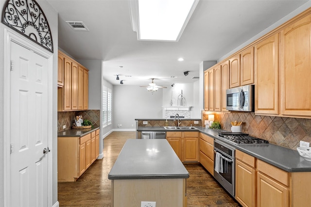 1557 Crystal Pass, Allen, TX 75002 - kitchen featuring stainless steel appliances, dark countertops, a kitchen island, recessed lighting, and light brown cabinetry