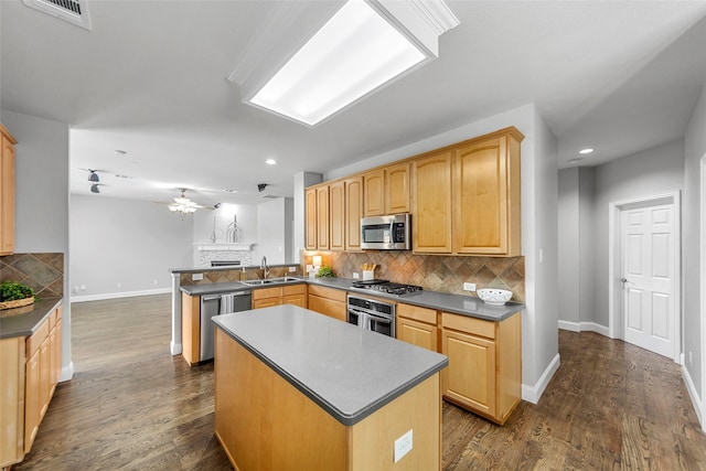 1557 Crystal Pass, Allen, TX 75002 - kitchen featuring stainless steel appliances, dark countertops, decorative backsplash, a peninsula, and a kitchen island