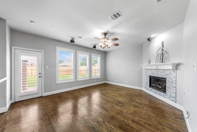 1557 Crystal Pass, Allen, TX 75002 - unfurnished living room featuring ceiling fan, a fireplace, and dark wood-type flooring
