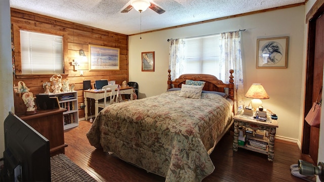 1307 Lakeshore Dr, Little Elm, TX 75068 - bedroom featuring wooden walls, a textured ceiling, wood finished floors, a ceiling fan, and crown molding