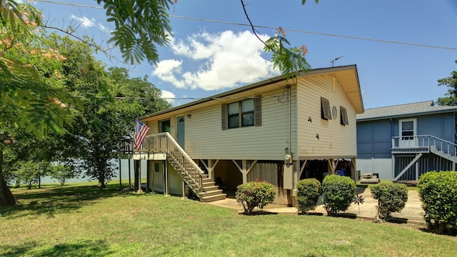1307 Lakeshore Dr, Little Elm, TX 75068 - rear view of house with stairs and a lawn