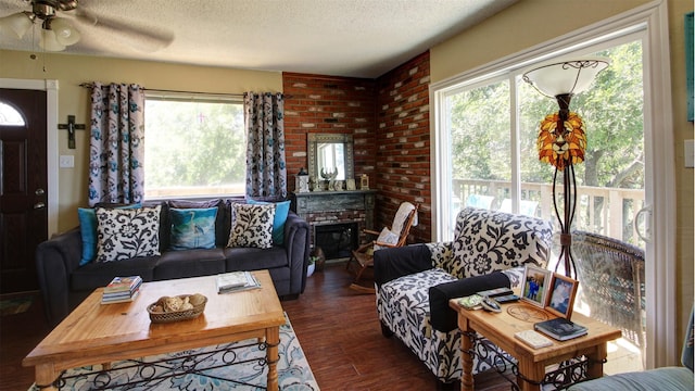 1307 Lakeshore Dr, Little Elm, TX 75068 - living room featuring a textured ceiling, healthy amount of natural light, ceiling fan, and dark wood-style flooring