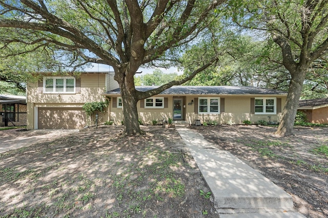 2225 Wooded Acres Dr, Waco, TX 76710 - split level home with a garage, driveway, and brick siding