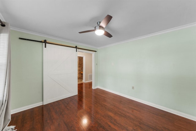 2225 Wooded Acres Dr, Waco, TX 76710 - unfurnished bedroom featuring wood finished floors, a barn door, ornamental molding, and a ceiling fan