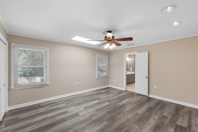 2225 Wooded Acres Dr, Waco, TX 76710 - unfurnished bedroom with wood finished floors, ornamental molding, ensuite bathroom, a ceiling fan, and a closet