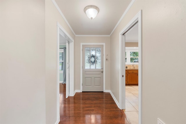 2225 Wooded Acres Dr, Waco, TX 76710 - entryway with crown molding, plenty of natural light, and light wood finished floors