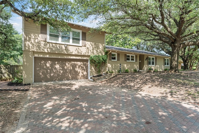 2225 Wooded Acres Dr, Waco, TX 76710 - view of front of property with brick siding, a garage, and decorative driveway