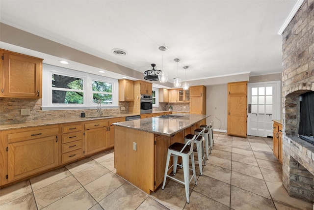2225 Wooded Acres Dr, Waco, TX 76710 - kitchen featuring appliances with stainless steel finishes, tasteful backsplash, a center island, light stone countertops, and crown molding