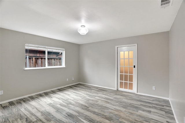 1510 Bowie St, Garland, TX 75042 - empty room with wood finished floors and baseboards