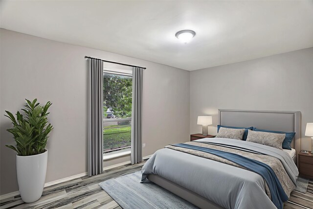 1510 Bowie St, Garland, TX 75042 - bedroom featuring light wood-style flooring and a baseboard radiator