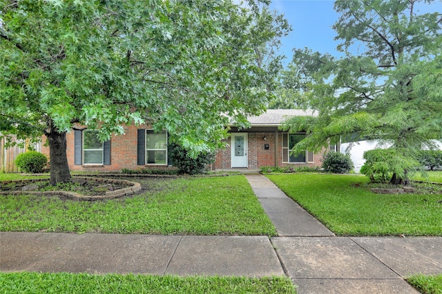 1510 Bowie St, Garland, TX 75042 - view of front of property with brick siding and a front lawn