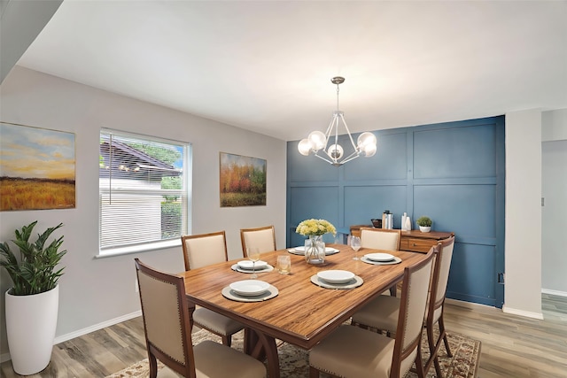 1510 Bowie St, Garland, TX 75042 - dining area featuring a decorative wall, light wood-type flooring, and a chandelier