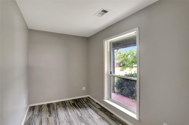 1510 Bowie St, Garland, TX 75042 - spare room featuring baseboards and wood finished floors