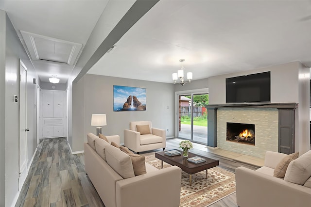 1510 Bowie St, Garland, TX 75042 - living area featuring wood finished floors, a fireplace, and attic access