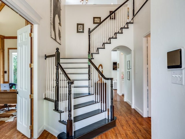 4112 Edith Ct, Dallas, TX 75220 - staircase with wood finished floors and arched walkways