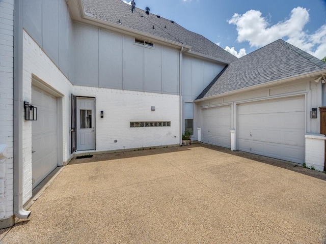 4112 Edith Ct, Dallas, TX 75220 - view of side of home featuring roof with shingles, board and batten siding, brick siding, concrete driveway, and an attached garage