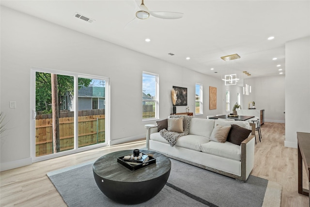 601 S Moore St, Dallas, TX 75203 - living room featuring recessed lighting, light wood-style flooring, a chandelier, a ceiling fan, and baseboards