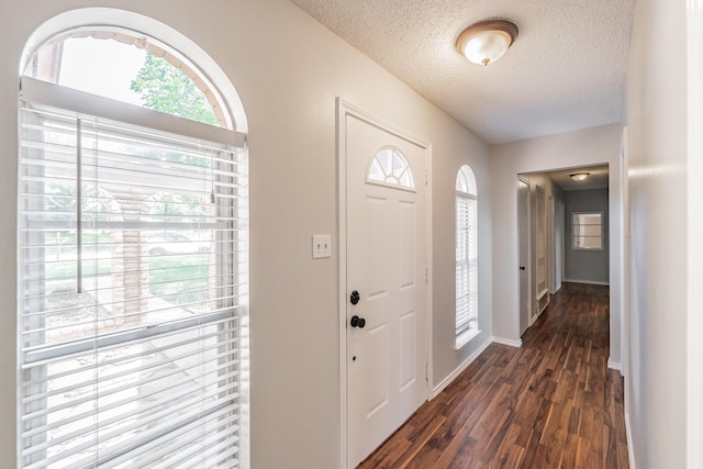 708 Simpson Ter, Bedford, TX 76021 - foyer with dark wood-style floors, a textured ceiling, plenty of natural light, and baseboards